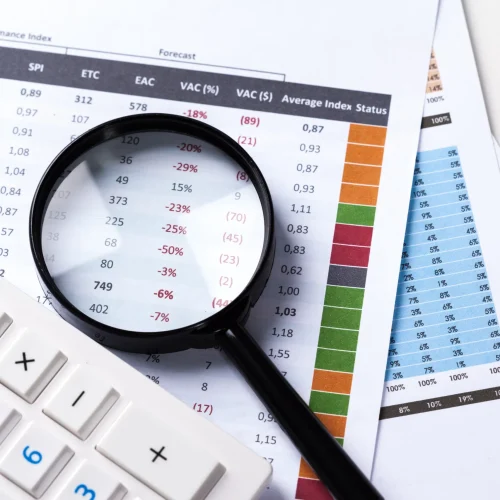 work-with-magnifying-glass-calculator-papers